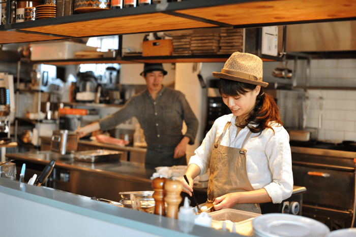 You can see the staff in the open kitchen as they quickly prepare your meal. Notice the fashionable uniforms as well.
