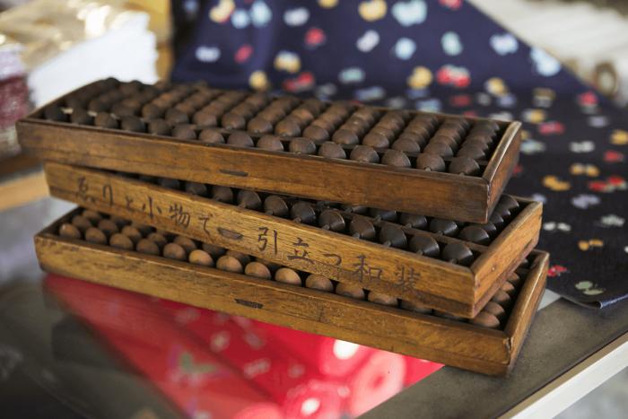 We spied some five-bead soroban, engraved with the words, “Japanese dress made to stand out with eri (collars) and accessories”