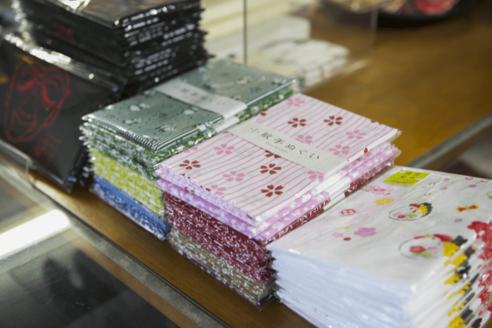 Tenugui cotton towels in Japanese designs that many customers buy as souvenirs.